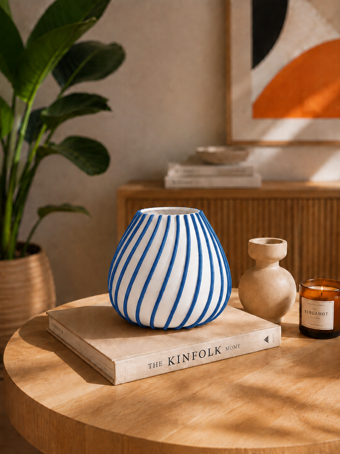 Afrikaans 3D printed designer vase with elegant blue sculptural lines on a white base, displayed in a warm modern interior as a statement piece for contemporary home decor.