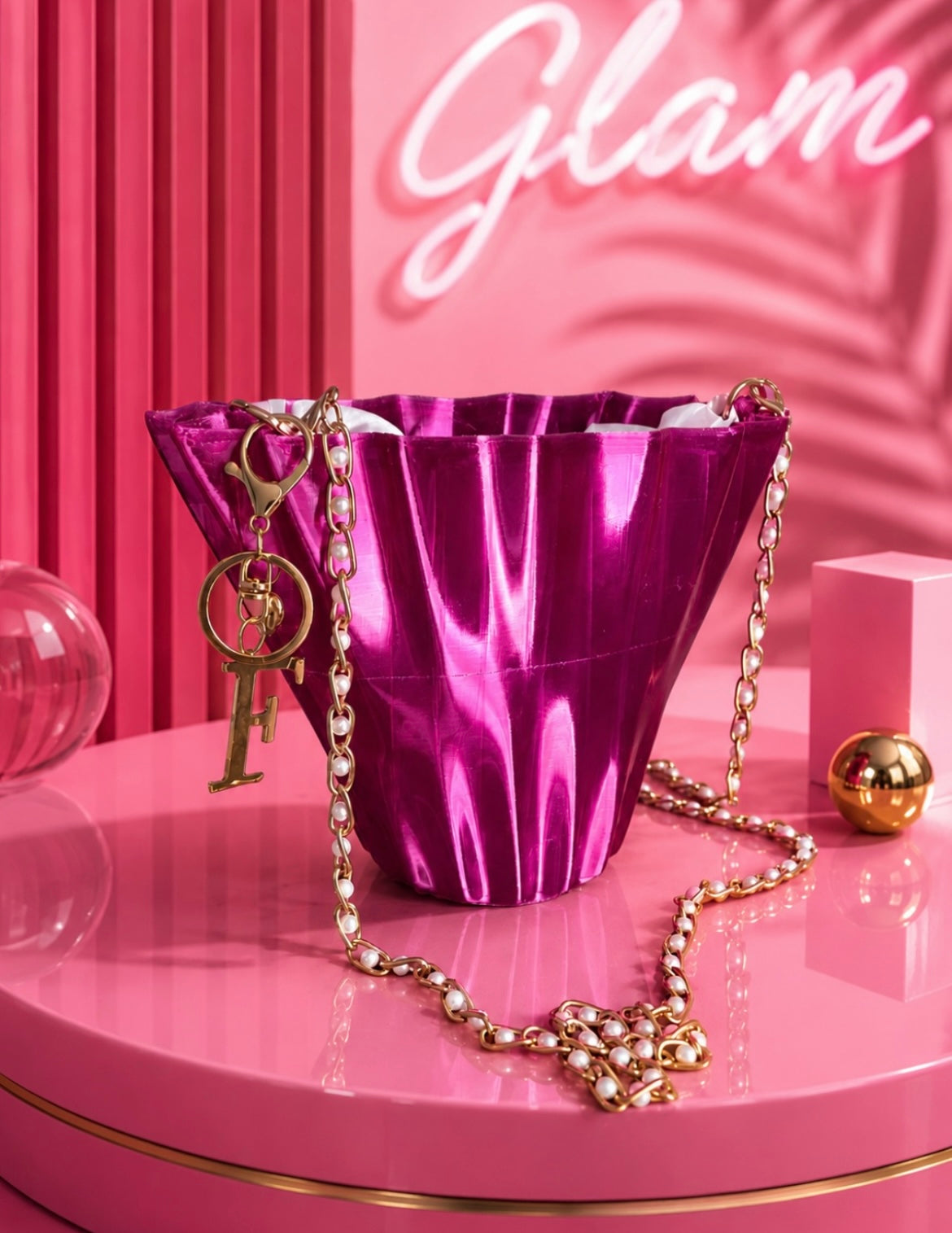 Woman wearing Aurora Fold luxury designer bag in glossy pink TPU with gold chain shoulder strap