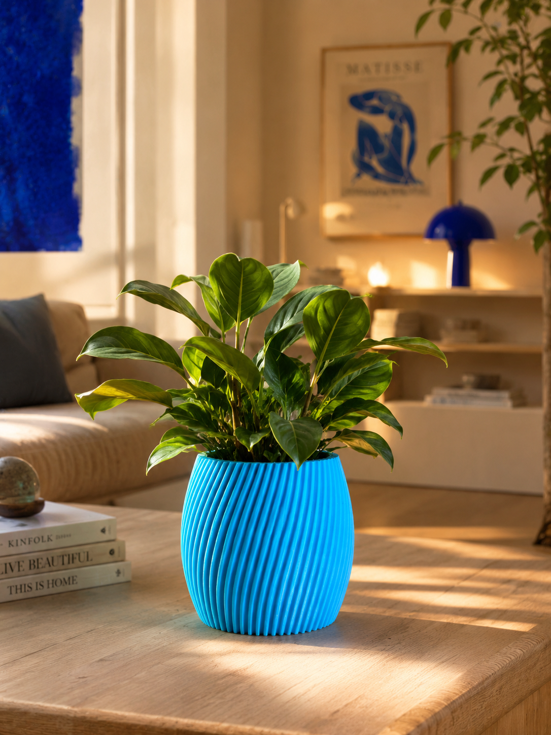 Modern blue planter pot with green indoor plant on wooden table in luxury living room, contemporary home decor and interior design.
