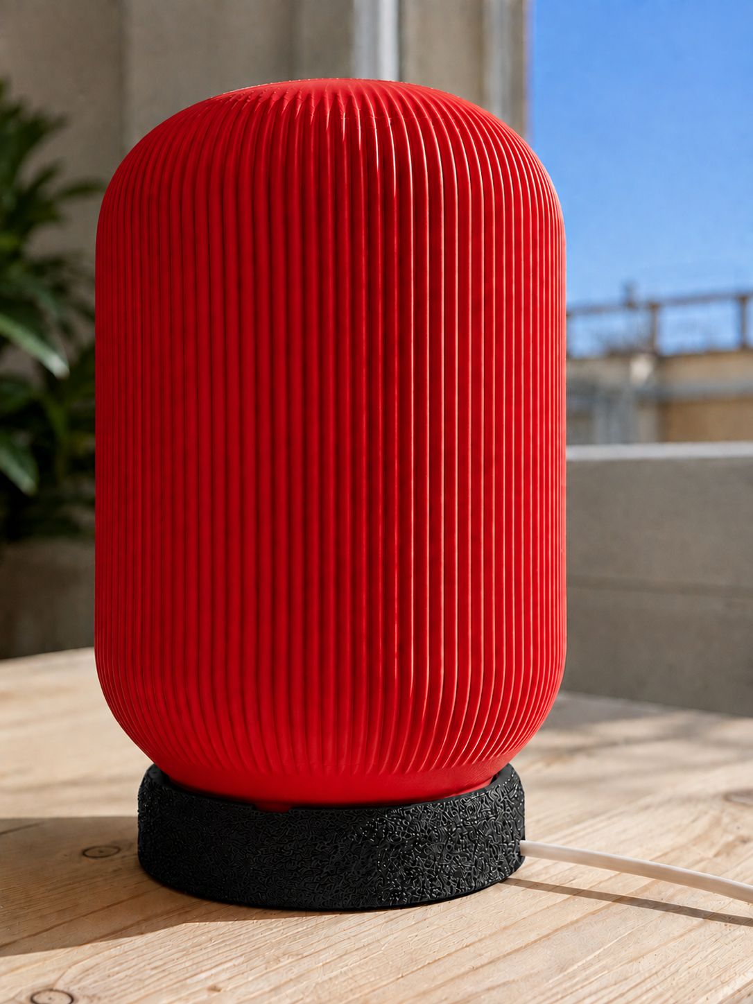 Modern 3D printed table lamp with a vibrant red ribbed shade and textured black base, featuring a minimalist contemporary design for bedrooms, bedside tables, living rooms and modern home decor.