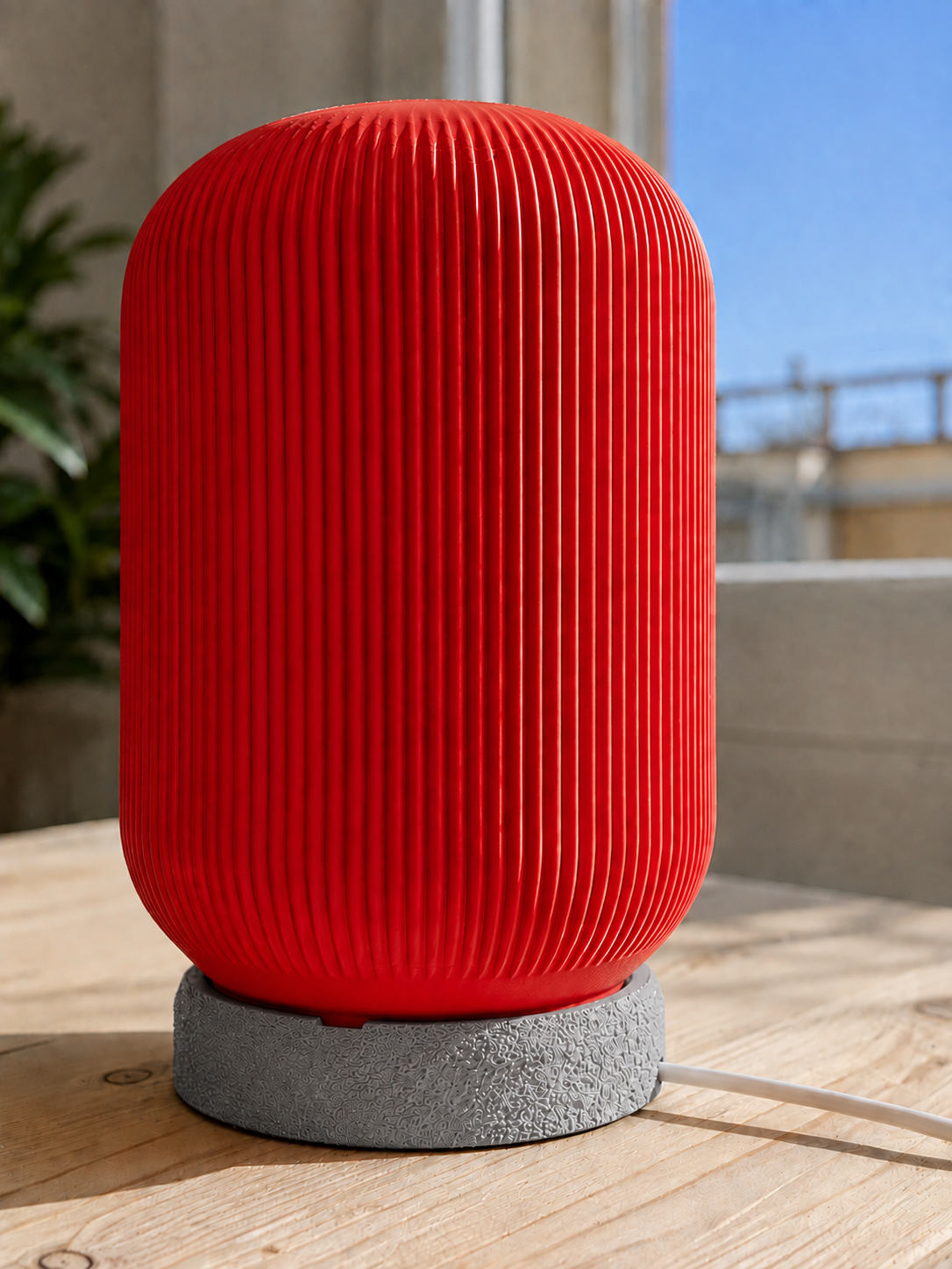 Modern 3D printed table lamp with a vibrant red ribbed shade and textured grey base, featuring a contemporary minimalist design for bedrooms, bedside tables, living rooms and modern home decor.