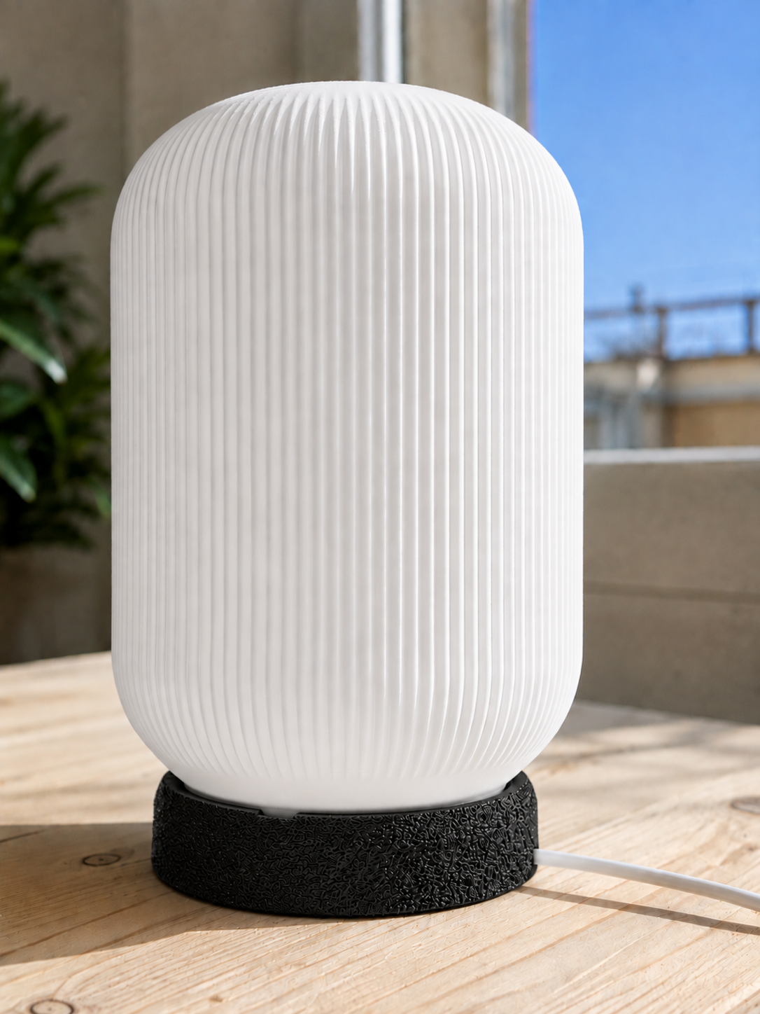 Modern 3D printed table lamp with a white ribbed shade and textured black base, featuring a minimalist contemporary design ideal for bedrooms, bedside tables, living rooms and modern home decor.