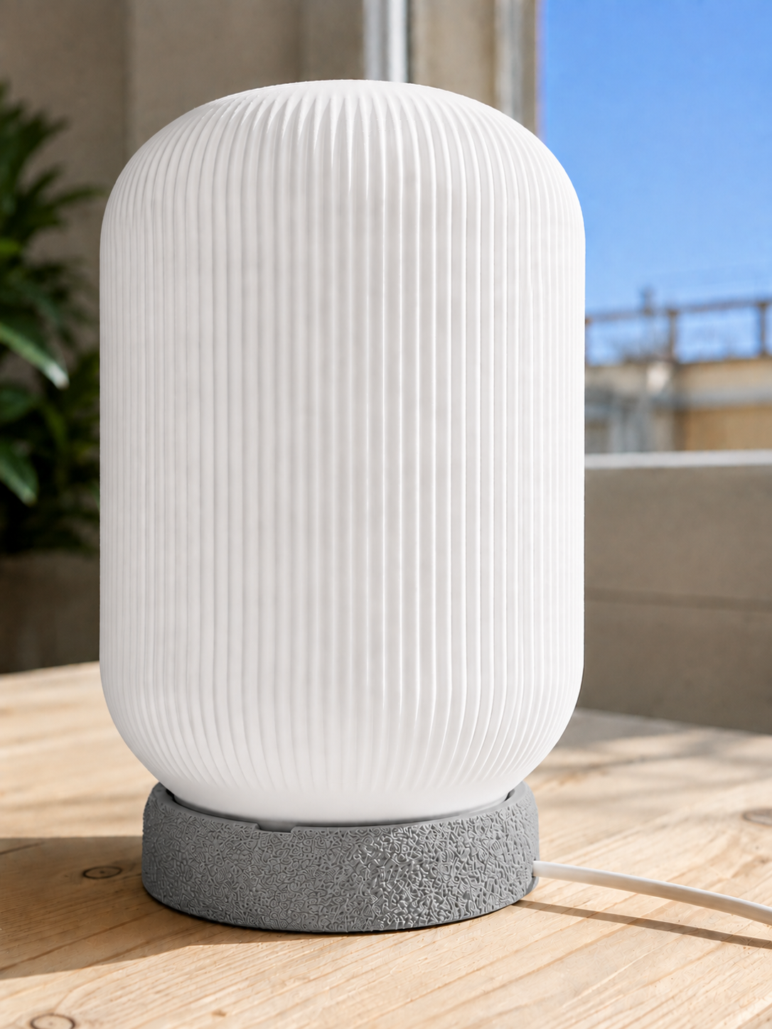 Modern 3D printed table lamp with a white ribbed shade and textured grey base, featuring a minimalist contemporary design for bedrooms, bedside tables, living rooms and modern home decor.