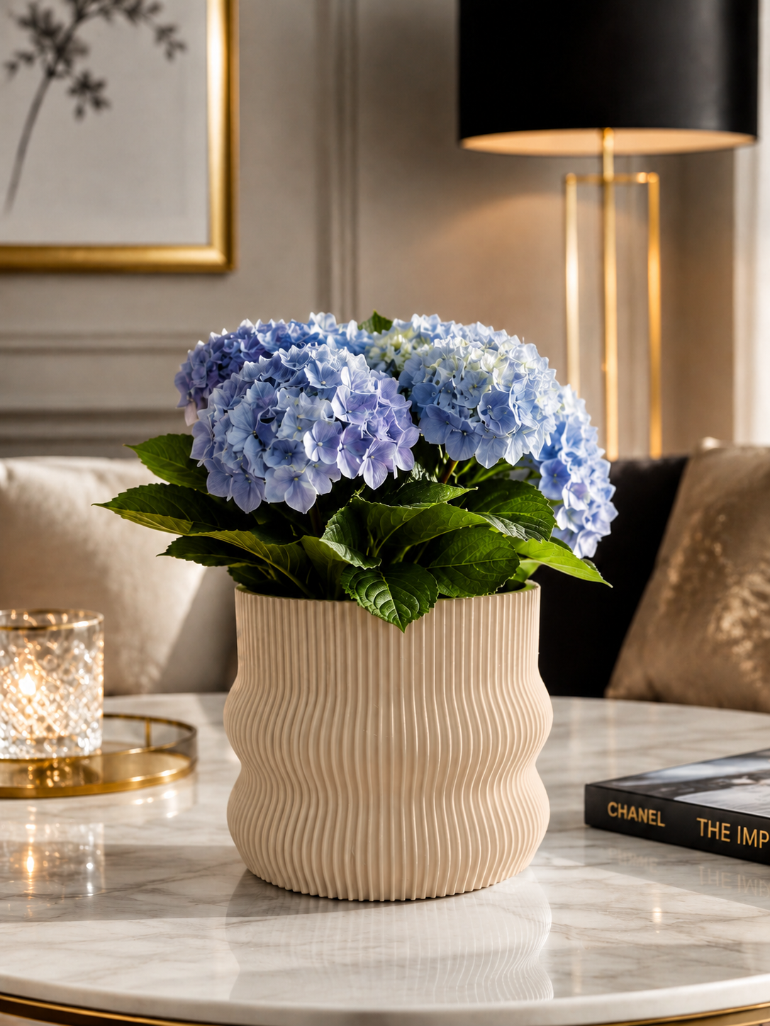 Elegant beige 3D printed planter crafted from premium PETG with a contemporary ribbed design. Decorative indoor plant pot featuring blue hydrangeas, perfect for luxury home décor, modern living rooms, office styling, minimalist interiors, Scandinavian décor and designer spaces. Proudly designed and made in Italy.