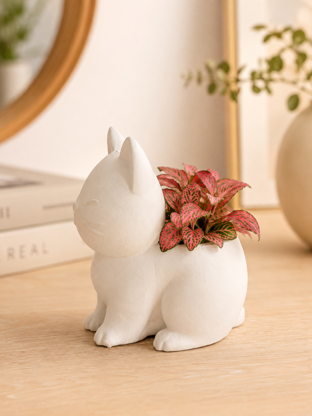Elegant white cat planter featuring a colorful decorative plant, designed to add charm to living rooms, offices and modern interiors. A unique gift for cat lovers.