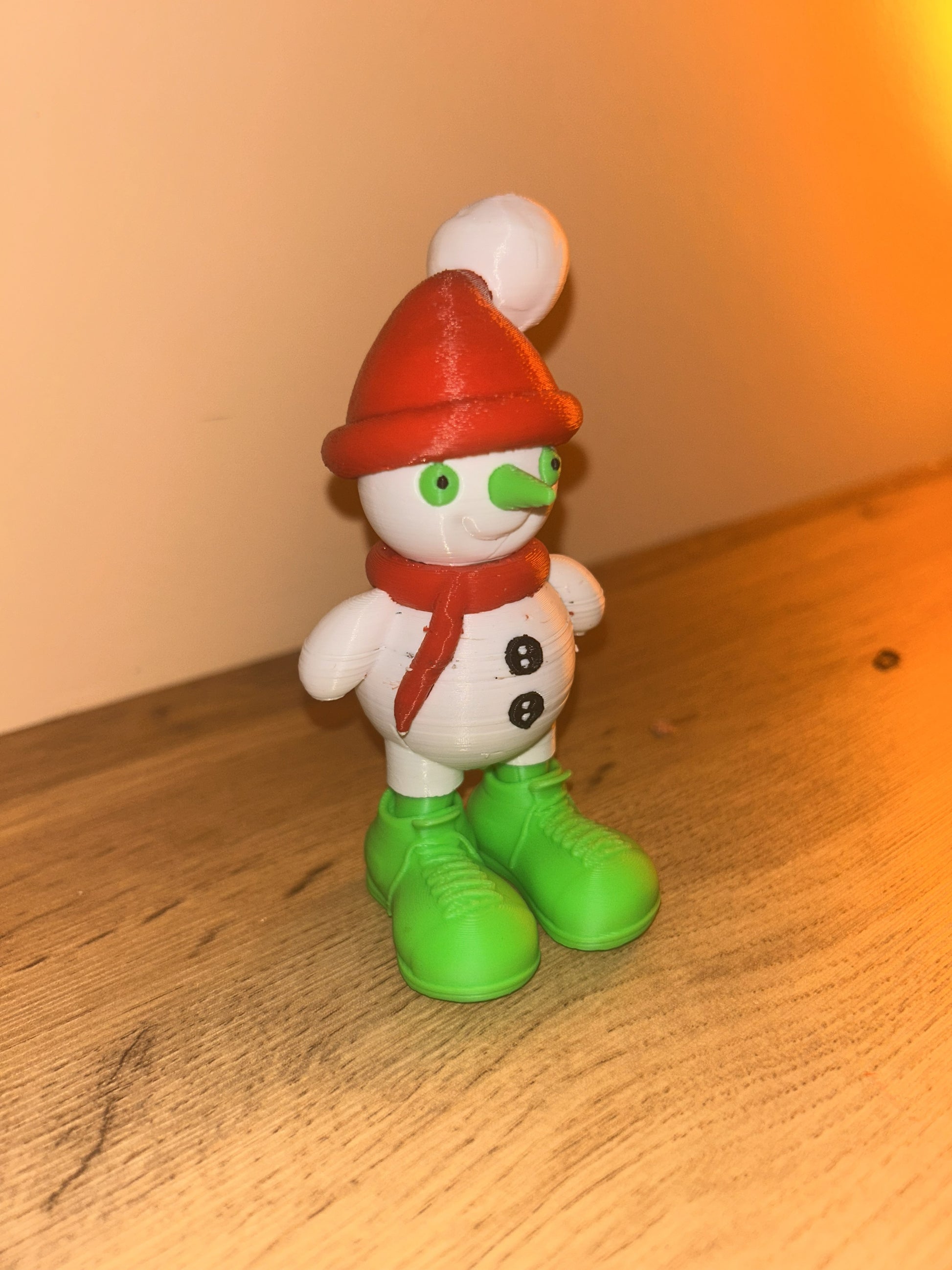 Vista laterale del Pupazzo di Neve Fjoccoloso stampato in 3D in PLA, design giocoso e colorato