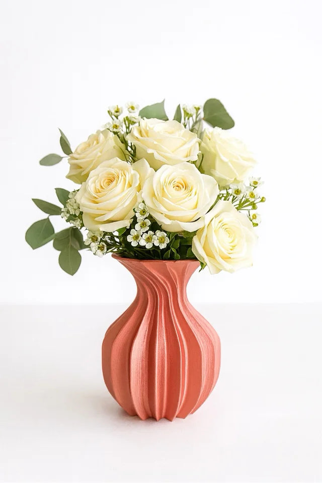 Elegant pink flower vase holding white roses, modern interior decoration accessory.