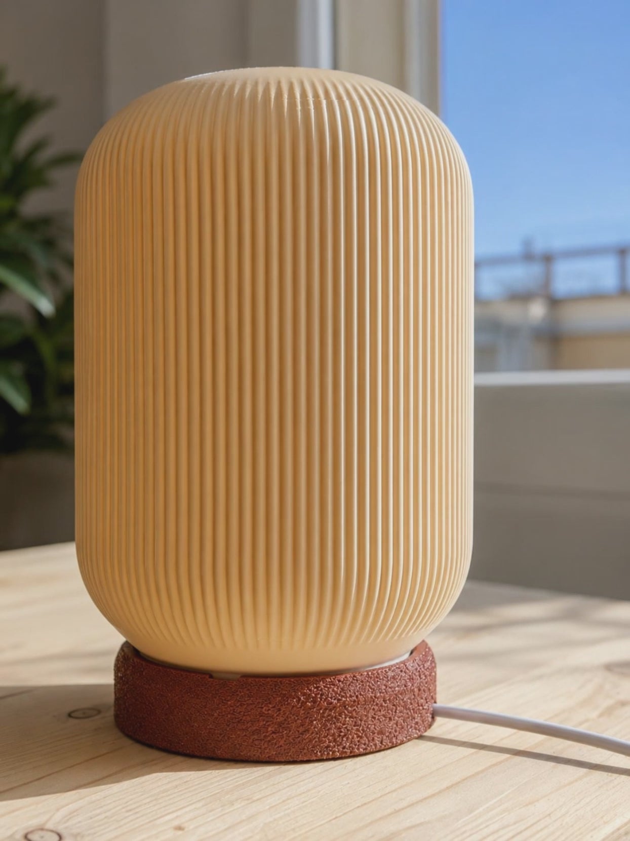 Discover a modern designer table lamp created to bring warmth, texture and contemporary elegance into your interior. Featuring a distinctive ribbed shade, sculptural silhouette and richly textured base, this compact accent lamp becomes a decorative statement even when switched off.