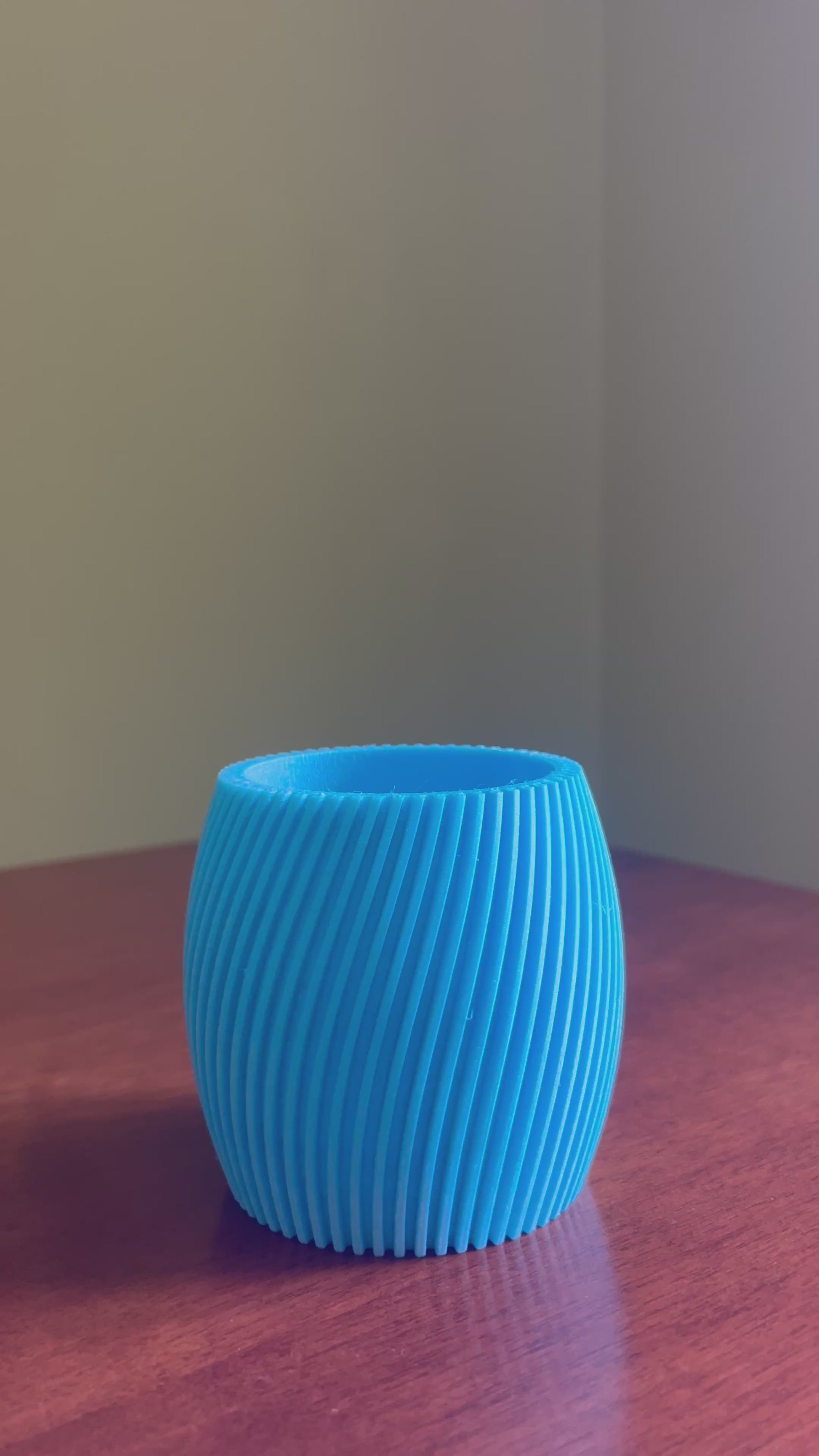 Elegant blue designer planter pot showcasing modern curved design, perfect for indoor plants, flowers, home decor, contemporary interiors and luxury living spaces.