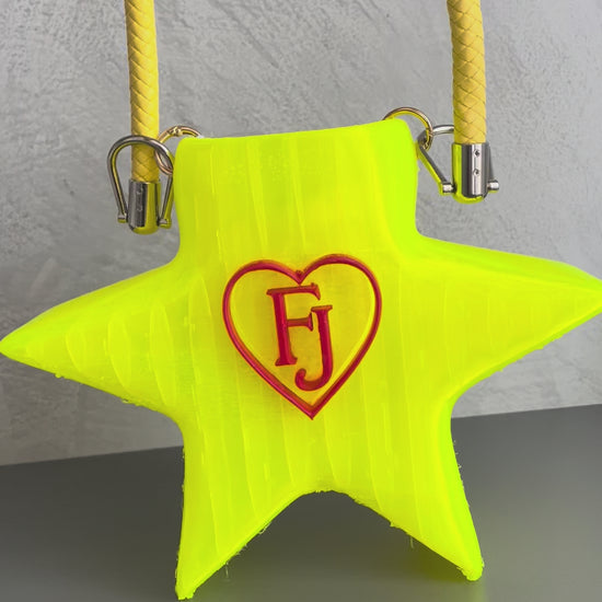 Stella Cometa fluorescent TPU star-shaped handbag photographed outdoors on a tree-lined avenue - demonstration video